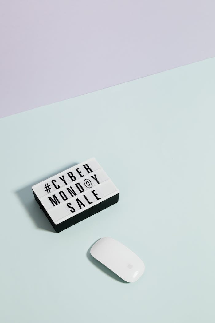 Stylish minimalist photo featuring Cyber Monday sale sign with mouse on pastel background.